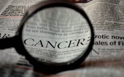 cancer word under magnifier
